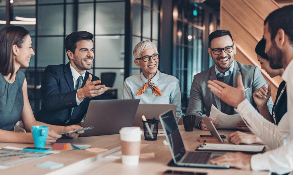 Photo of a confident business leader facilitating a meeting—representing the role of an EOS® Integrator